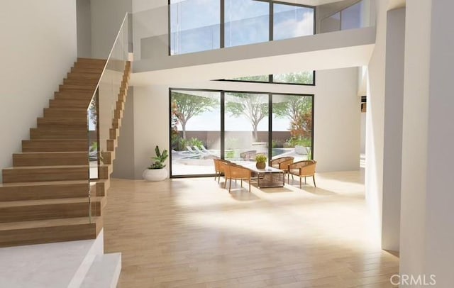 interior space with hardwood / wood-style flooring and a towering ceiling