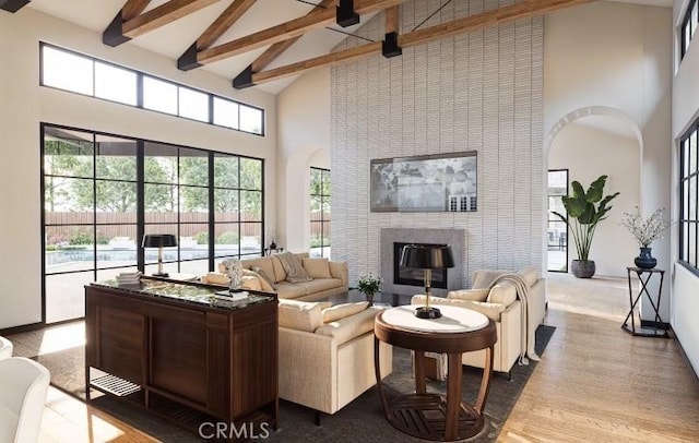 living room featuring a fireplace, high vaulted ceiling, and beamed ceiling