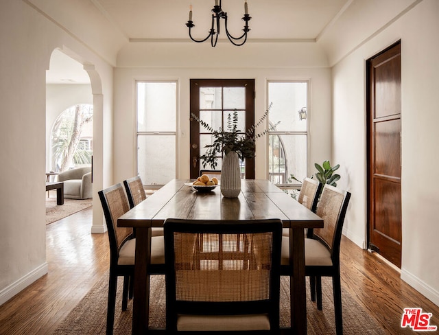 dining space with a notable chandelier and wood-type flooring