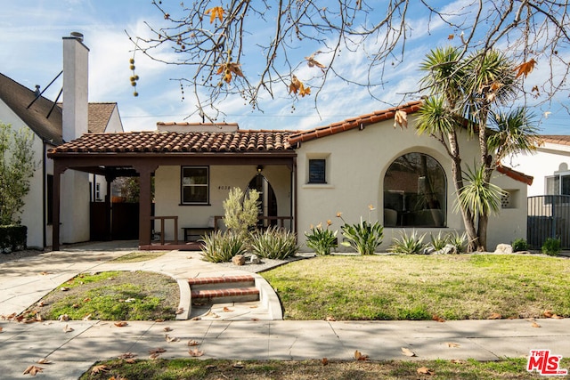 back of house with a carport and a yard