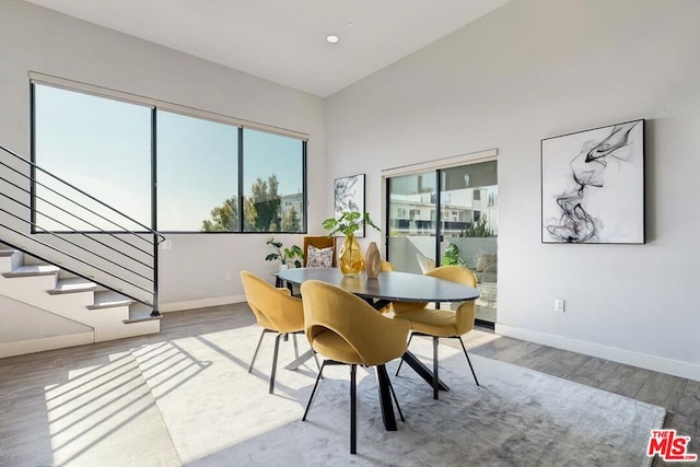 dining area featuring a healthy amount of sunlight and hardwood / wood-style floors