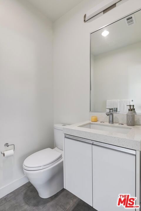 bathroom featuring vanity and toilet