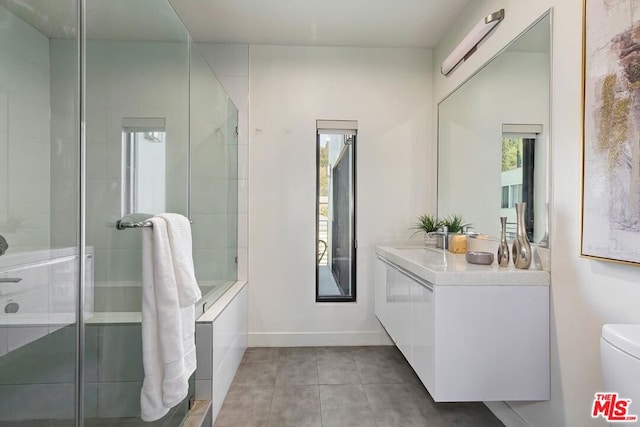 bathroom with walk in shower, tile patterned floors, vanity, and toilet