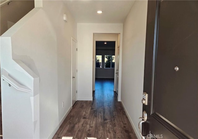 corridor featuring dark hardwood / wood-style floors