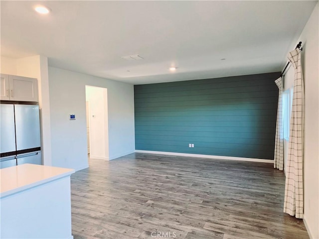 kitchen featuring stainless steel refrigerator and dark wood-type flooring