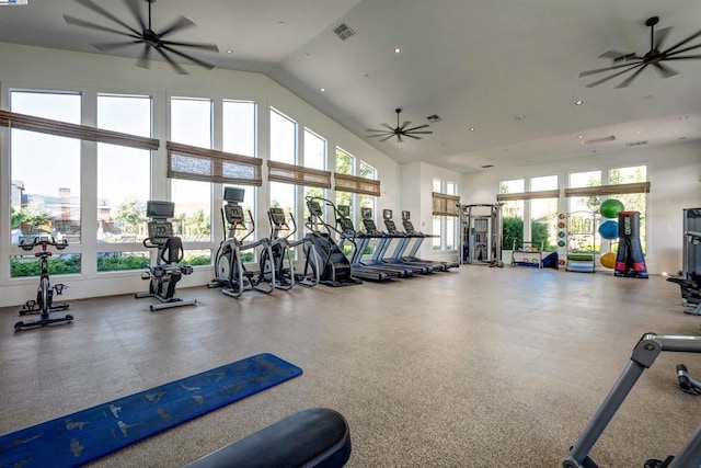 exercise room with ceiling fan and high vaulted ceiling