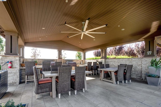 view of patio featuring exterior bar and ceiling fan