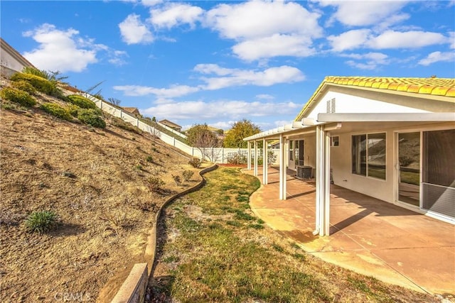 view of yard with cooling unit and a patio area