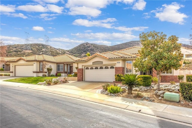 mediterranean / spanish-style house featuring a mountain view and a garage