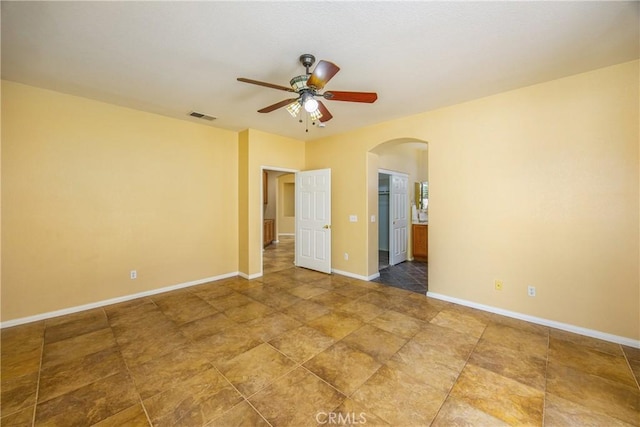 unfurnished room with ceiling fan