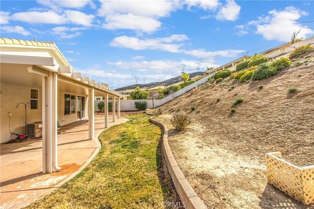 view of yard with central AC unit and a patio