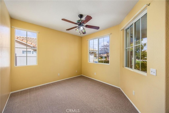 empty room with carpet flooring and ceiling fan