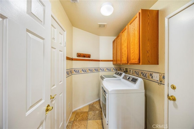 laundry area featuring cabinets and washing machine and dryer