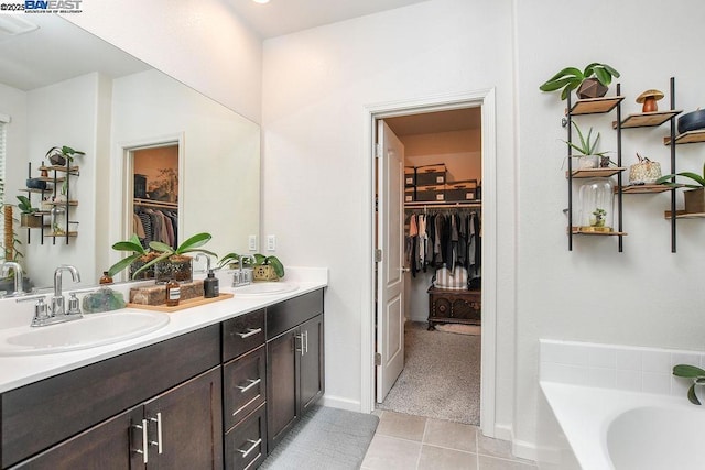 bathroom featuring tile patterned floors, vanity, and a bathing tub