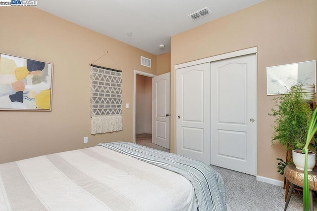 carpeted bedroom with a closet