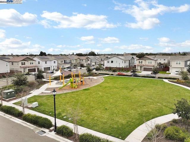 view of home's community featuring a playground and a lawn