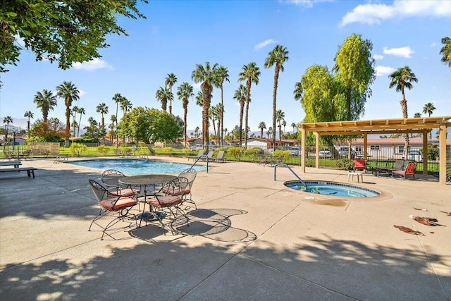 view of swimming pool featuring a community hot tub, a pergola, and a patio