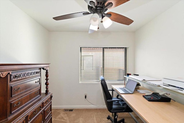 carpeted office space featuring ceiling fan