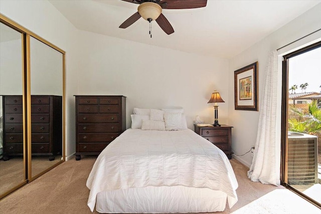 bedroom featuring ceiling fan, a closet, and light carpet