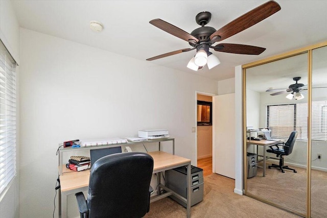 carpeted office with ceiling fan