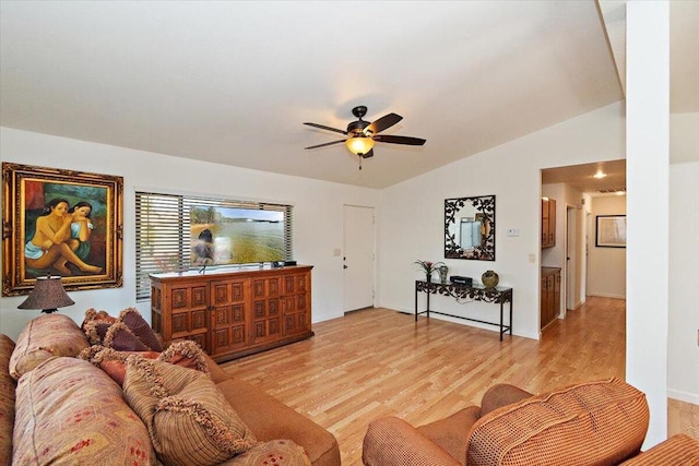 living room with lofted ceiling, ceiling fan, and light wood-type flooring