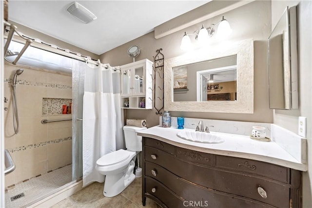 bathroom featuring tile patterned floors, toilet, a shower with shower curtain, and vanity