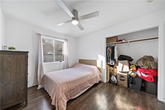 bedroom with dark hardwood / wood-style floors, ceiling fan, and a closet