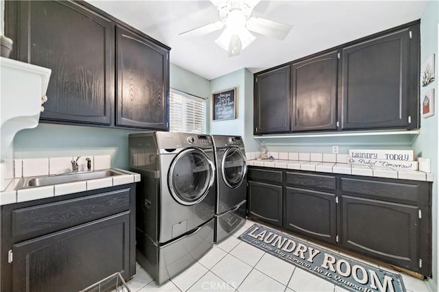 laundry room featuring sink, cabinets, separate washer and dryer, light tile patterned floors, and ceiling fan