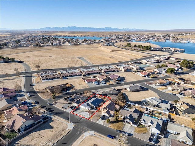 birds eye view of property featuring a water and mountain view