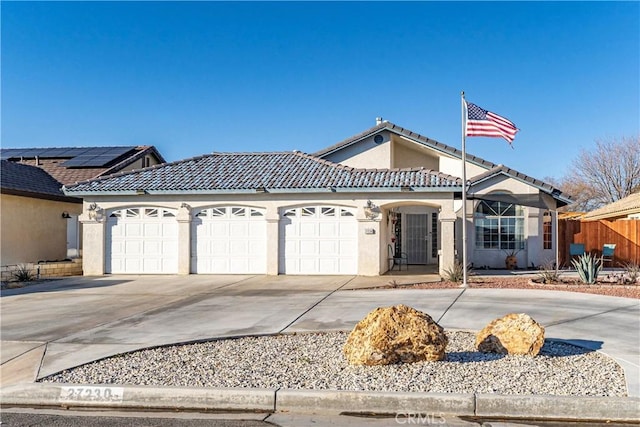 view of front facade with a garage and solar panels