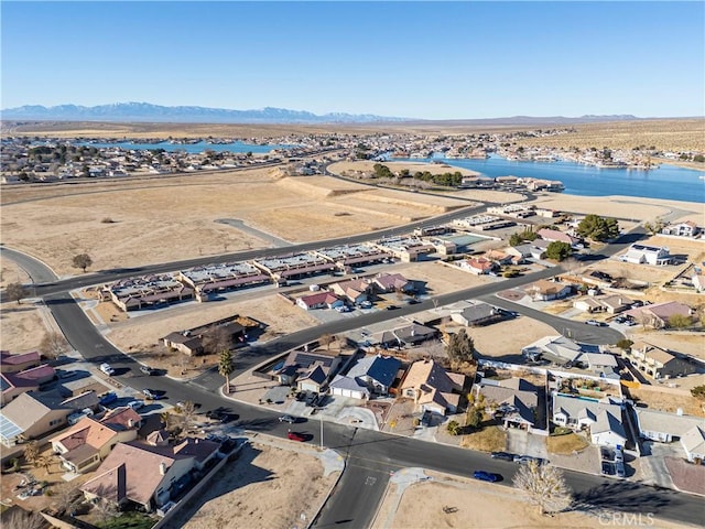 birds eye view of property featuring a water and mountain view