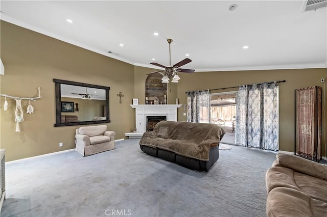 living room featuring ceiling fan, ornamental molding, and carpet flooring