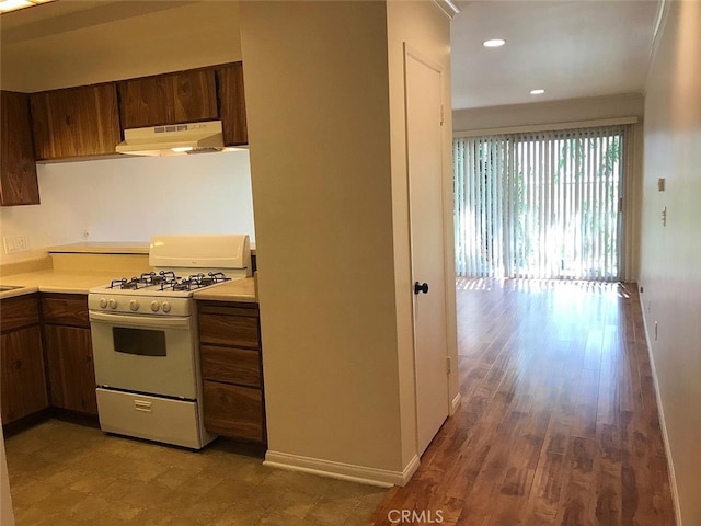 kitchen with hardwood / wood-style flooring and white gas range oven