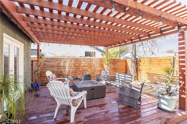 wooden terrace with an outdoor fire pit and a pergola