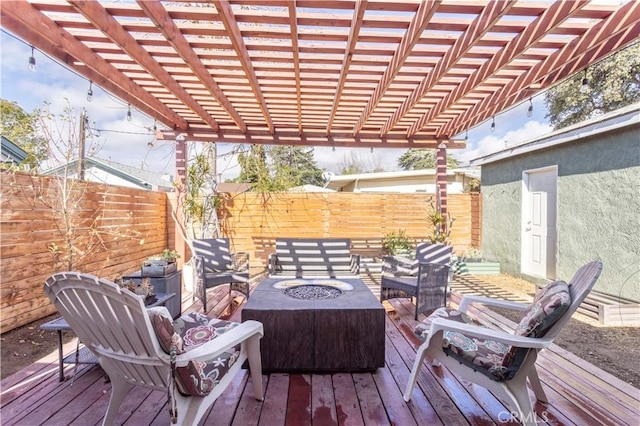 deck featuring an outdoor fire pit and a pergola