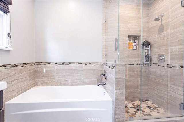 bathroom featuring vanity and independent shower and bath