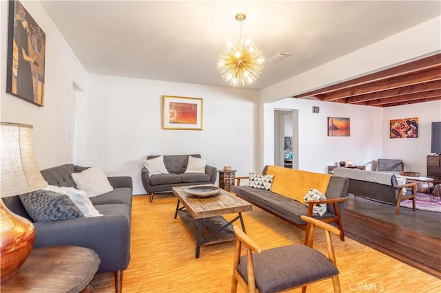 living room with beam ceiling, light wood-type flooring, and an inviting chandelier