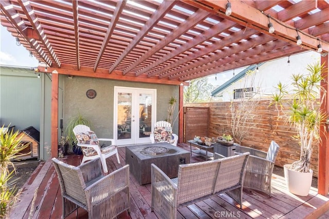 view of patio / terrace with french doors, an outdoor living space with a fire pit, a deck, and a pergola