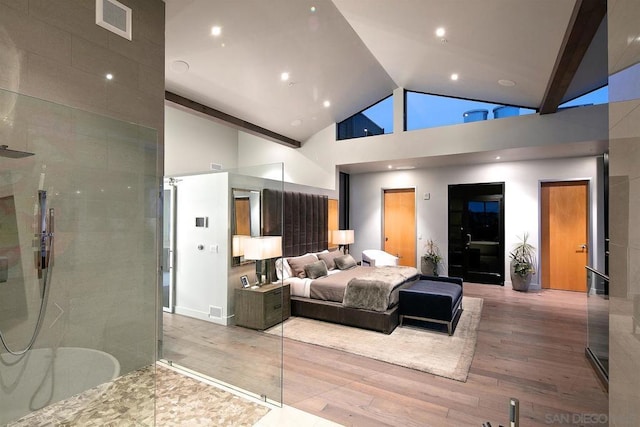 bedroom featuring hardwood / wood-style flooring and high vaulted ceiling