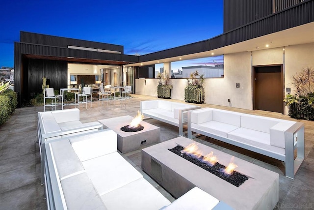 view of patio / terrace featuring an outdoor living space with a fire pit and elevator