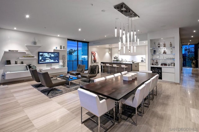 dining space with wine cooler and indoor bar