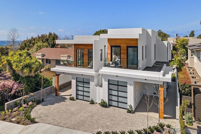 contemporary home featuring a garage and a balcony