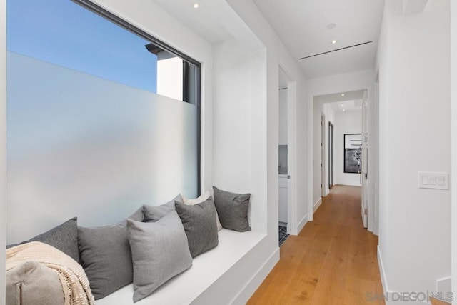 hallway with hardwood / wood-style flooring