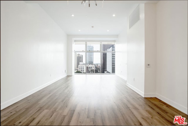 unfurnished room with light wood-type flooring