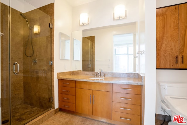 bathroom featuring vanity, tile patterned floors, and walk in shower