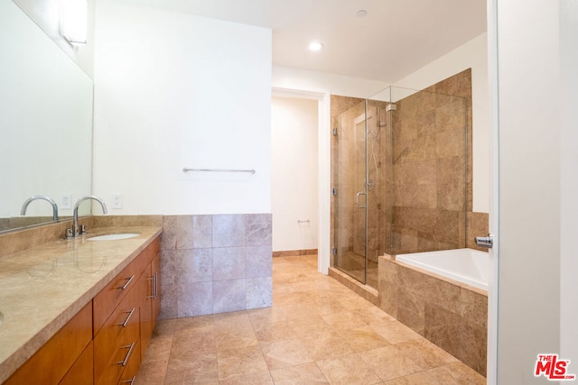 bathroom with independent shower and bath and vanity