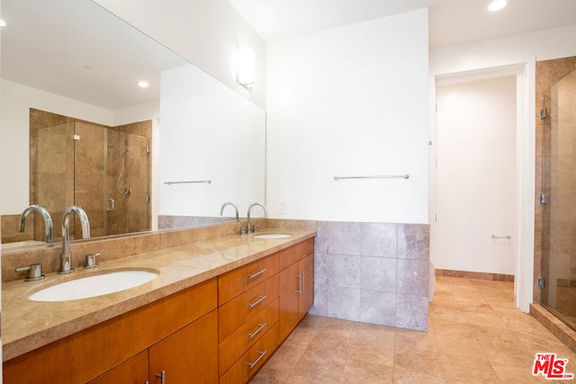 bathroom featuring vanity, tile patterned floors, and walk in shower