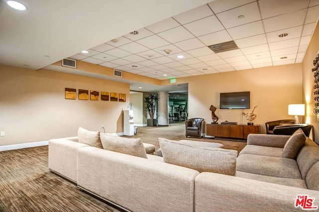 carpeted living room with a paneled ceiling