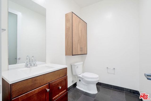 bathroom with vanity, tile patterned floors, and toilet