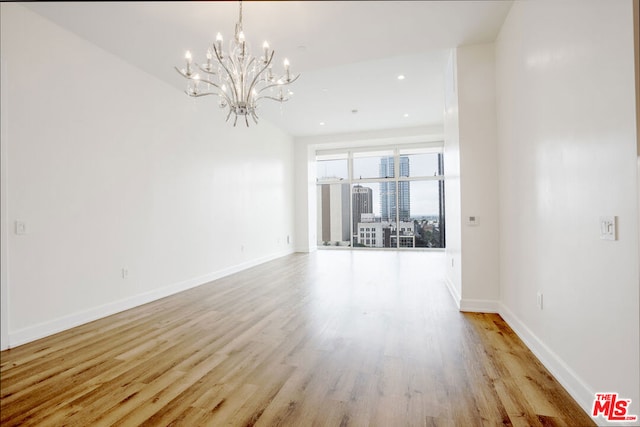 interior space with an inviting chandelier and light wood-type flooring